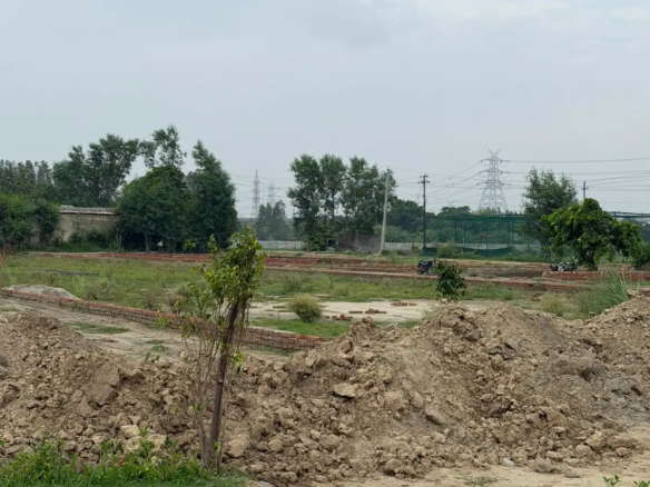 Residential construction site with high-rise apartment buildings in the background