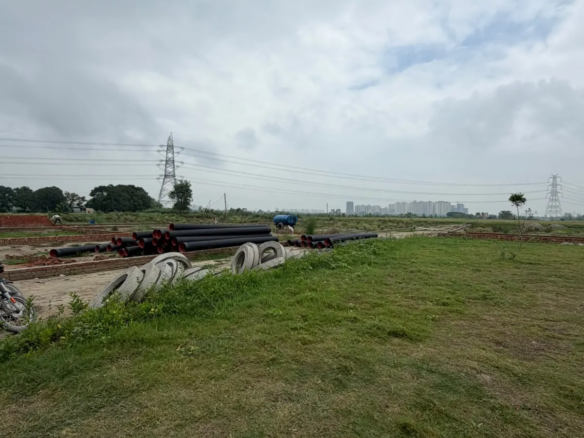 Residential project site showing infrastructure development, landscaped areas and electrical transmission lines